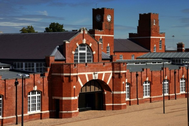 An image of Drill Hall Library with red brick and an arched frontway
