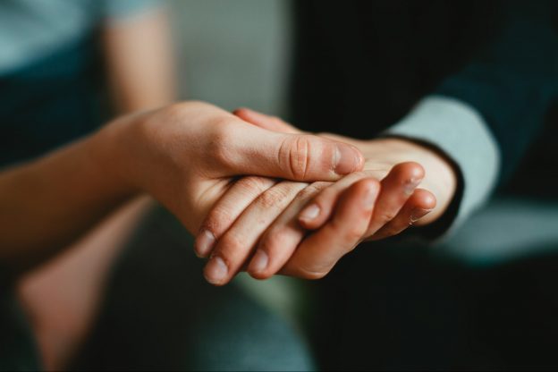 Man and a woman holding hands